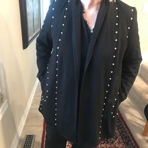 Black jacket with gold studs.